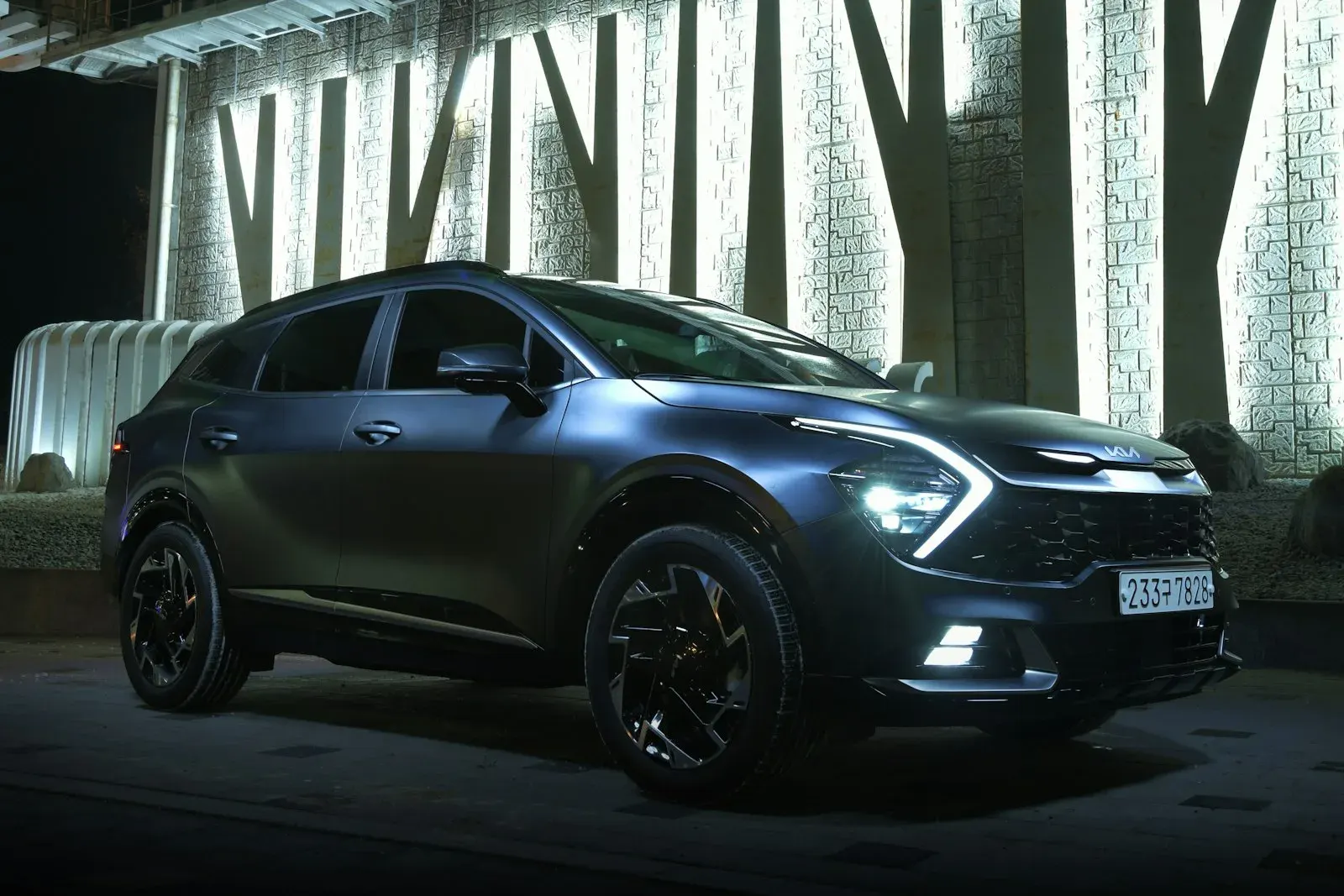 Black crossover SUV parked in front of a building