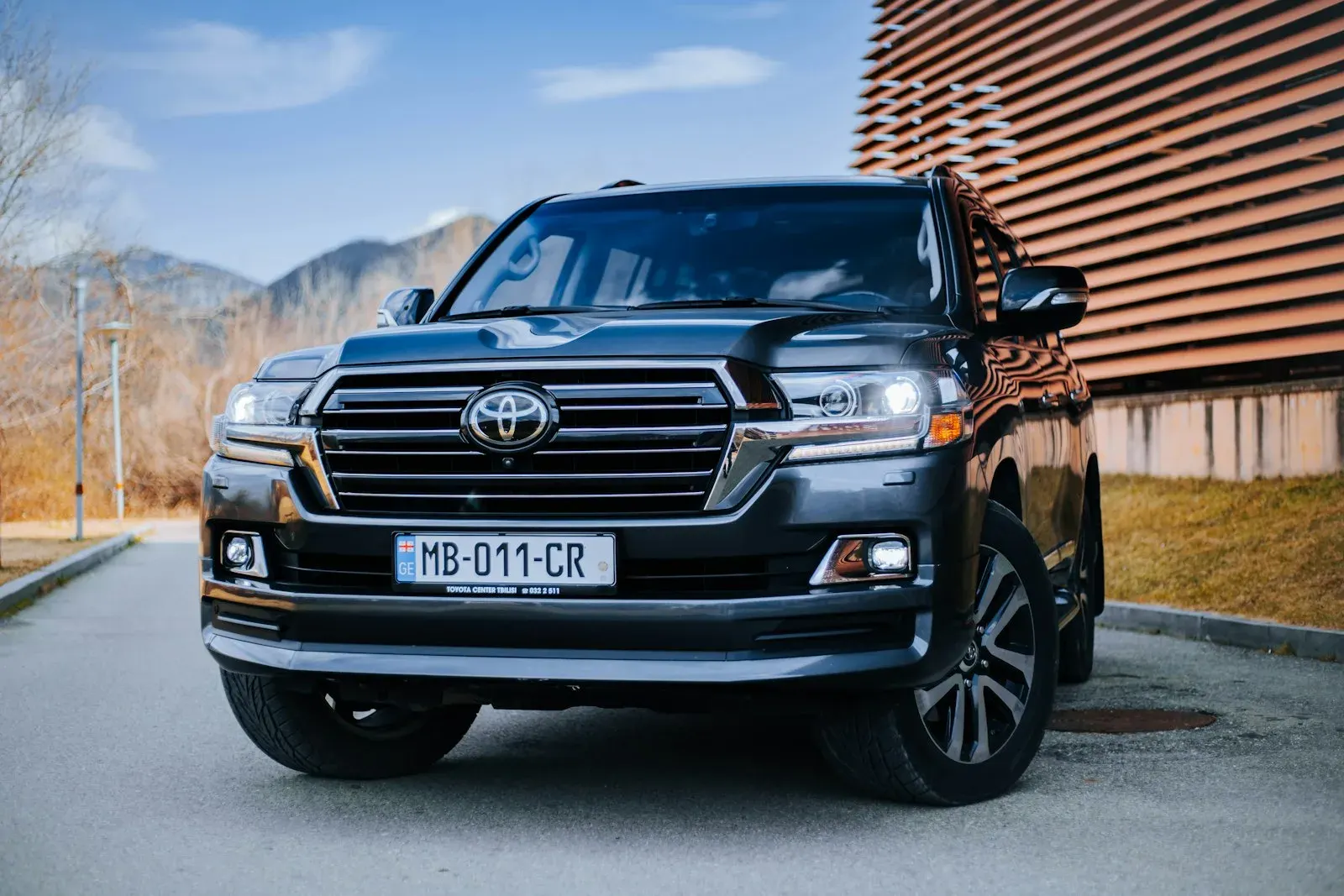 Black Toyota Land Cruiser parked in front of a building
