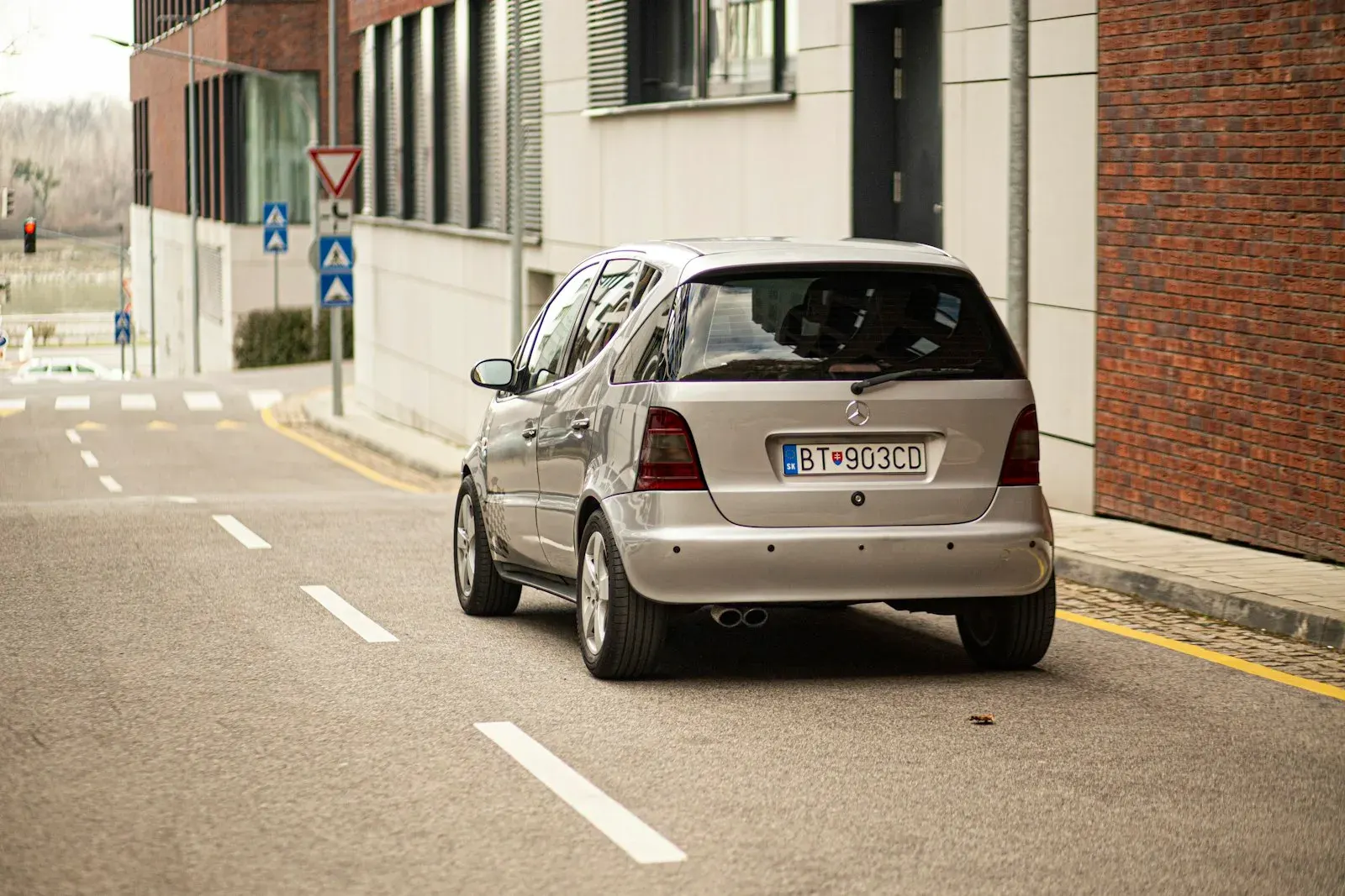 Silver compact hatchback parked at the roadside
