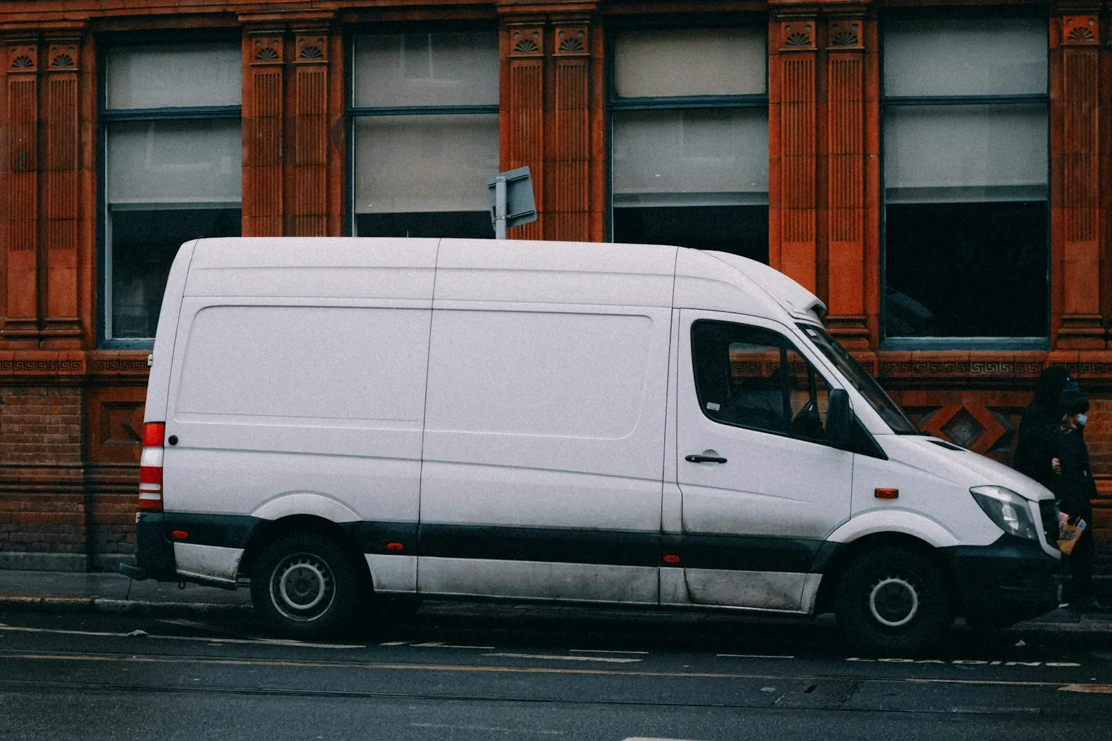 White passenger van parked at the roadside