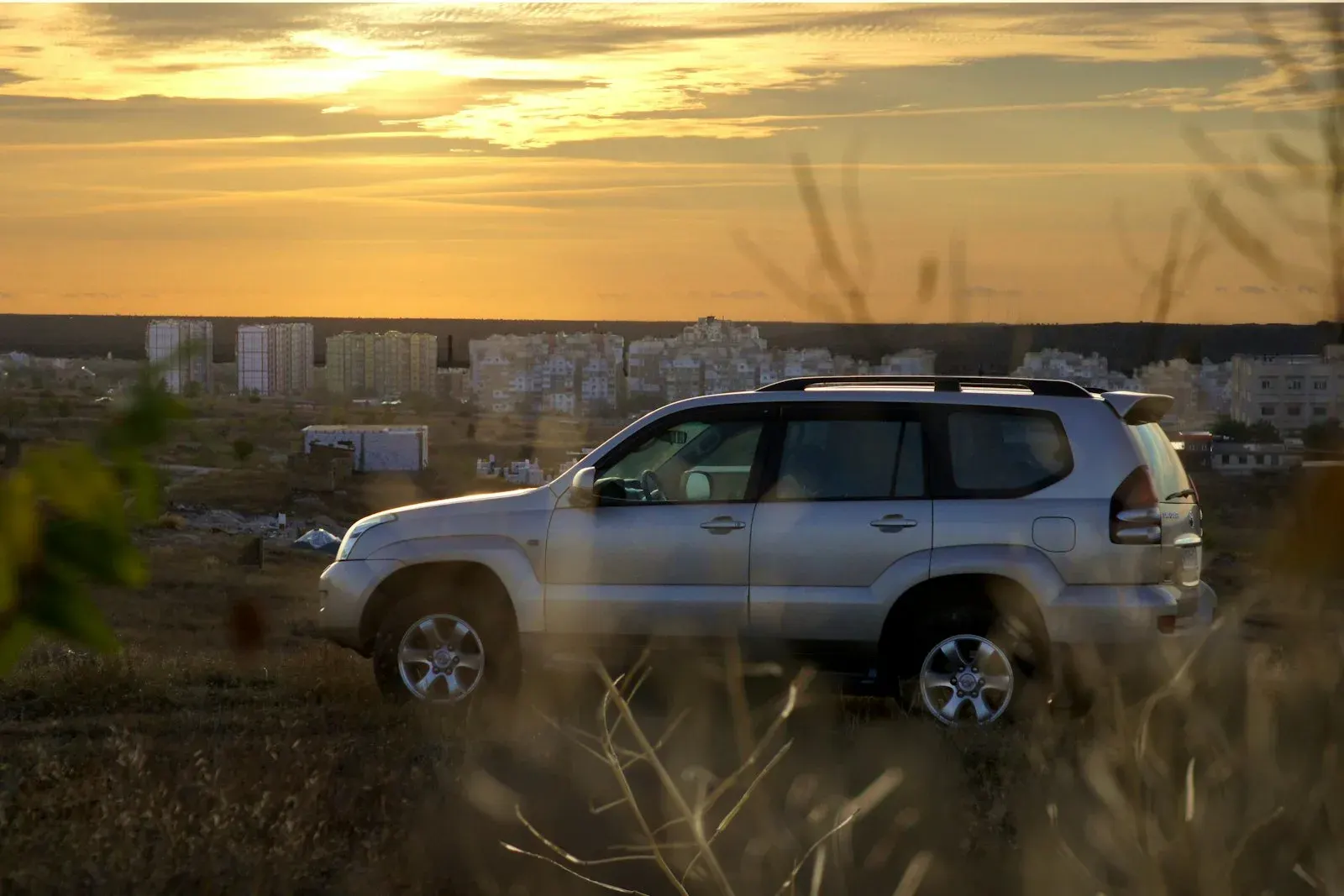 Grey four-wheel-drive SUV on open ground