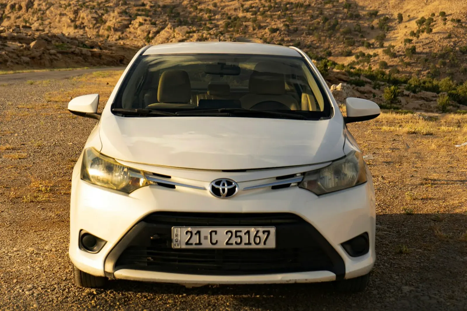 White Toyota sedan photographed head-on